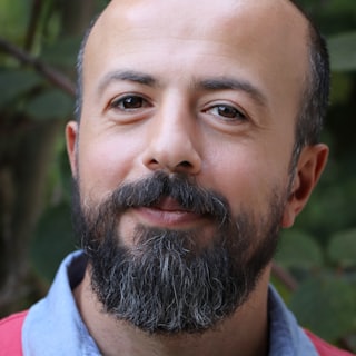 Portrait of Marcus T., a middle-aged man with a beard