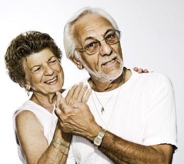 Portrait of Ruth and Gerald F., a smiling couple in their late sixties and early seventies
